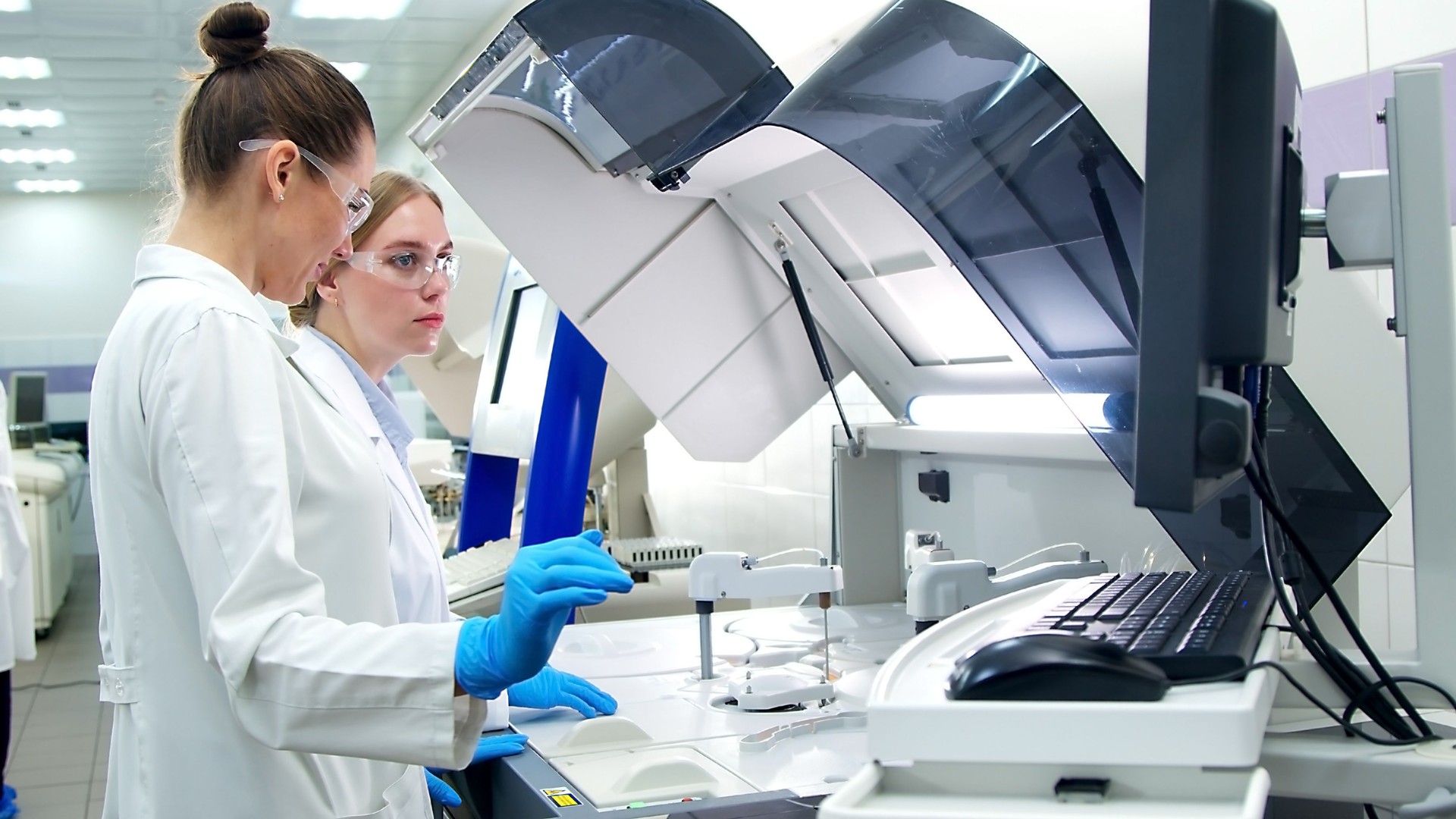 A medical research laboratory with a diverse team of biochemical scientists working with computers and modern medical technologies. Development of high-tech equipment for medicines.